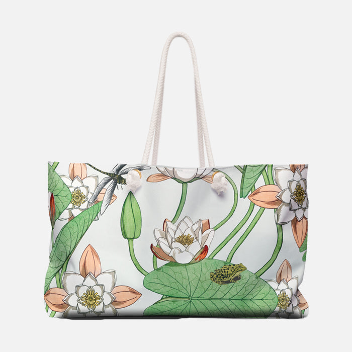 Tote bag with floral design featuring water lilies and a frog on a white background