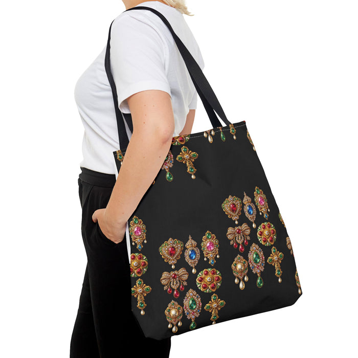 Black tote bag with decorative brooches held by a person on a white background