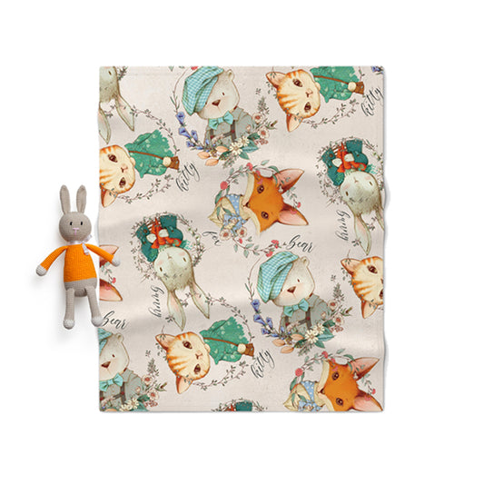 Floral-patterned fabric with animal illustrations and a small plush toy on a white background