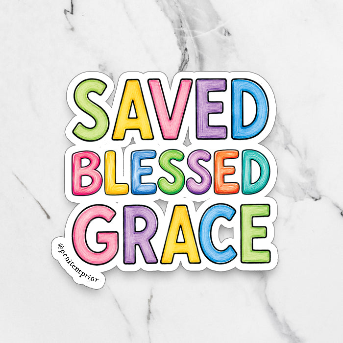 A die-cut fridge magnet with the words 'SAVED BLESSED GRACE' in colorful bubble letters, displayed on a white marble background. The sticker features a white border and a small brand tag reading '@penitentprint' in the lower-left corner