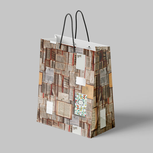 Paper gift bag with vintage book design on a gray background