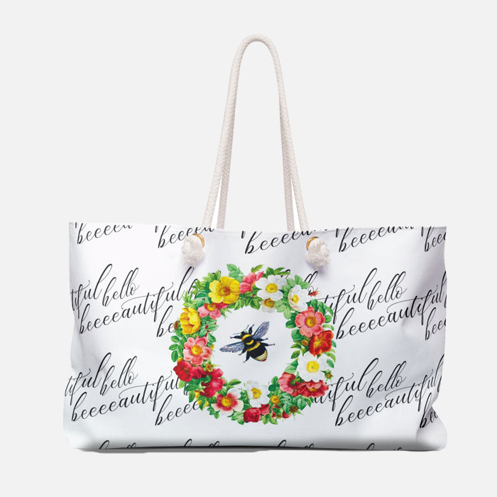 White tote bag with floral wreath and bee design on a white background
