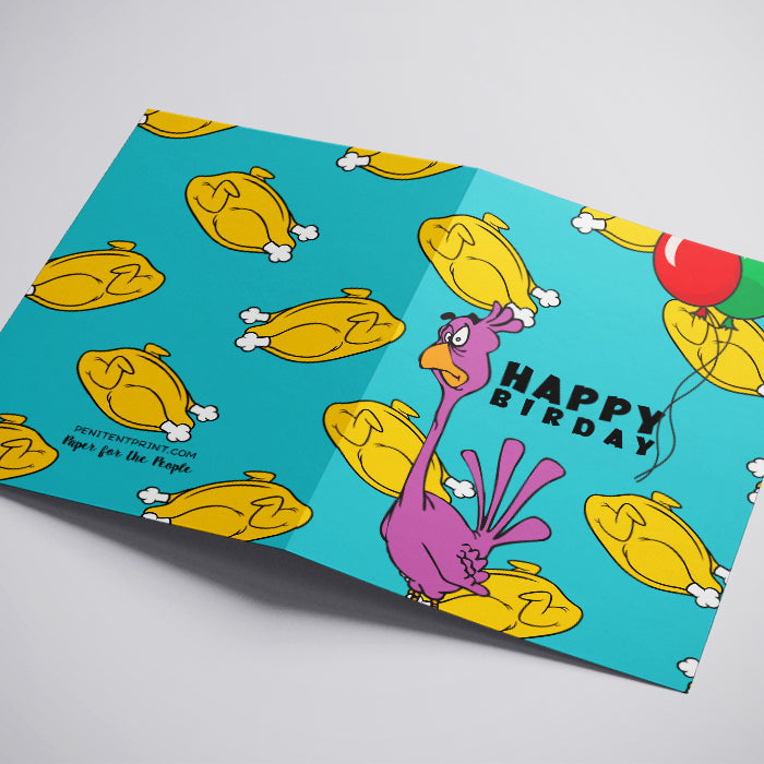 A folded greeting card shown on a light gray background. The card features a bright turquoise background with a repeating pattern of yellow roasted chickens, a pink cartoon turkey, a red and green balloon, and the words 'HAPPY BIRTHDAY' in black.