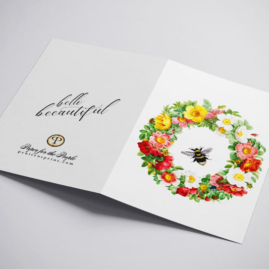 Open book with floral design and text on a light gray background