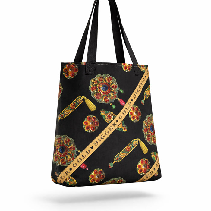 Black tote bag with colorful gem and ribbon design on a white background