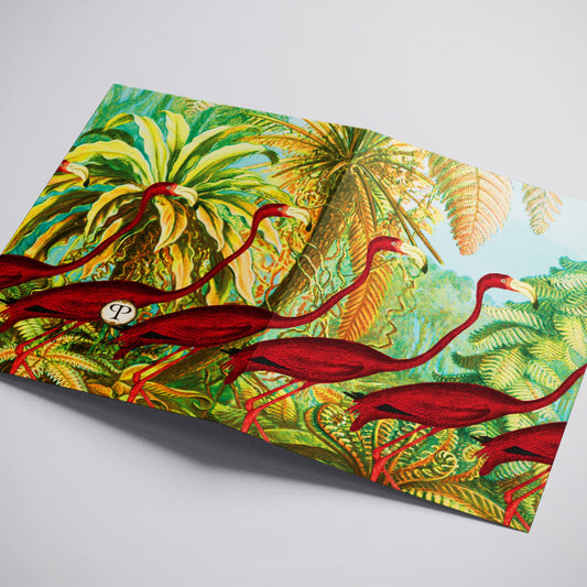 Fabric with a tropical design featuring red flamingos and green foliage on a white background