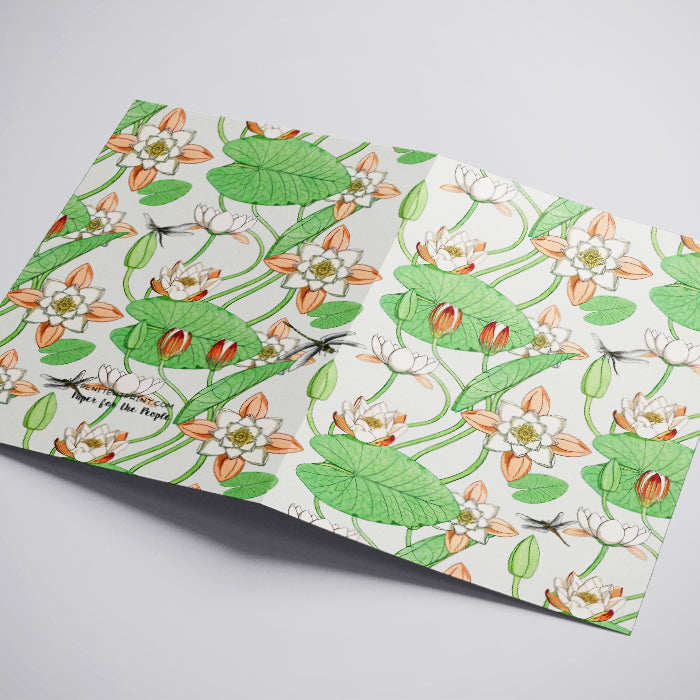Floral patterned paper with green leaves and orange flowers on a white background