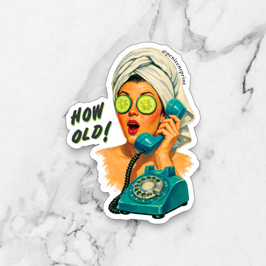 Magnet of a woman with a towel on her head, cucumbers over her eyes, and a teal rotary phone with 'HOW OLD!' text on a marble background.