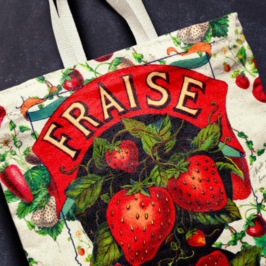 Tote bag with retro strawberry design and 'Fraise' text on a dark background