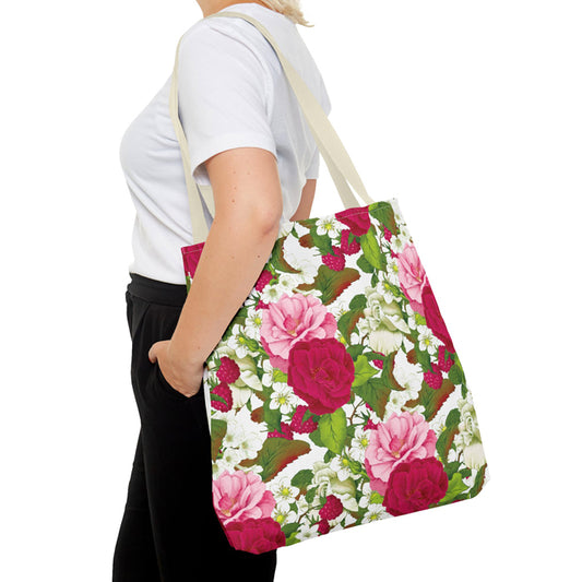 Person wearing a bright floral tote bag on a white background