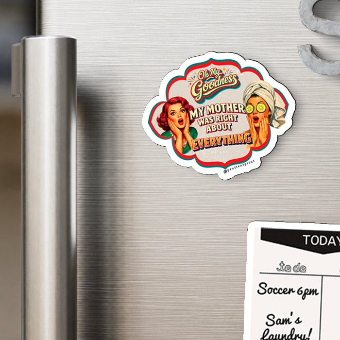 A die-cut refrigerator magnet with retro-style pin-up illustration and the text 'Old Glory's My Mother WAS RIGHT ABOUT EVERYTHING' is shown attached to a brushed stainless steel refrigerator door next to a white calendar page.