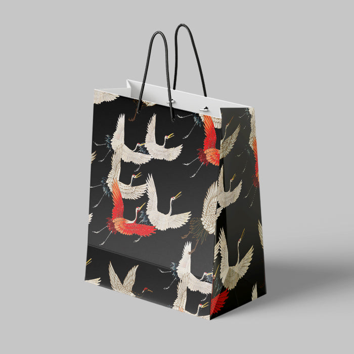 Gift bag with crane design on a gray background