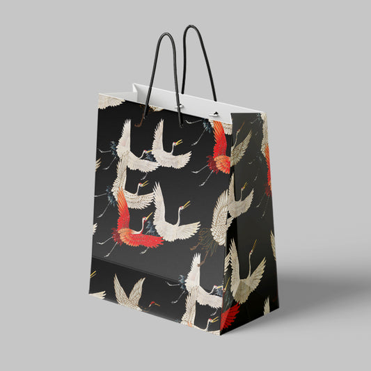 Gift bag with crane design on a gray background