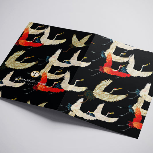 Decorative paper with crane design on a black background