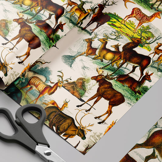 Sheets of paper with deer illustrations and a pair of scissors on a gray surface