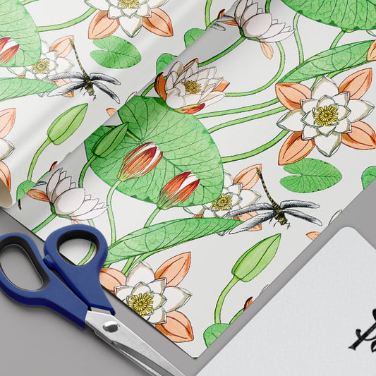 Decorative paper with floral design and scissors on a gray surface