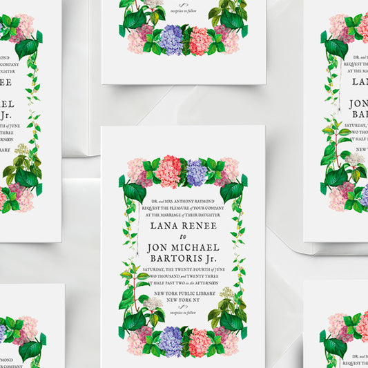 Floral wedding invitations with greenery on a white background