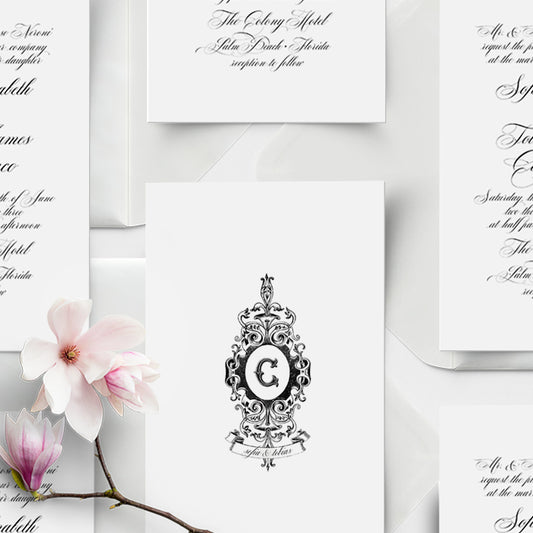 Elegant wedding invitation with floral design and decorative monogram on a white background