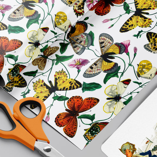Butterfly and floral patterned wrapping paper with scissors on a gray background